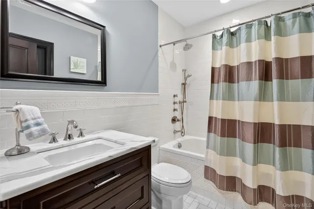 a living room with furniture and painting on the wall