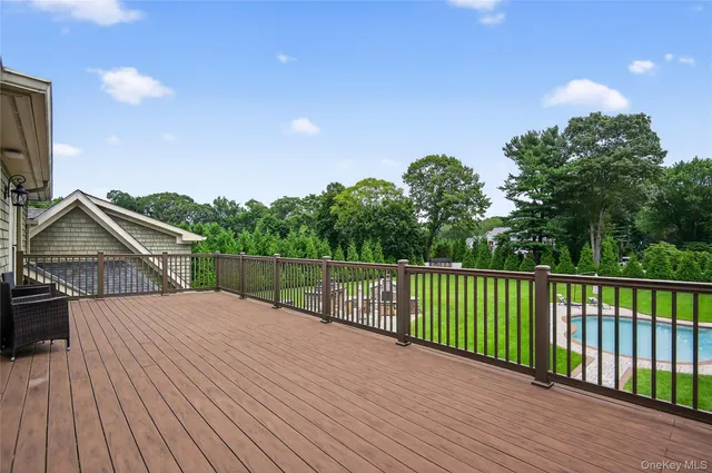 a view of a swimming pool with a table and chairs in the garden