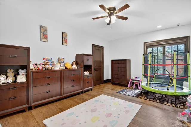 a bedroom with bed and wooden floor