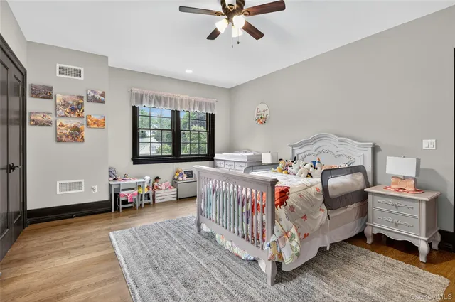 a bathroom with a double vanity sink toilet mirror and shower