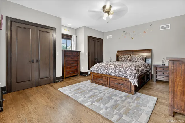 a bedroom with a large bed and a chandelier