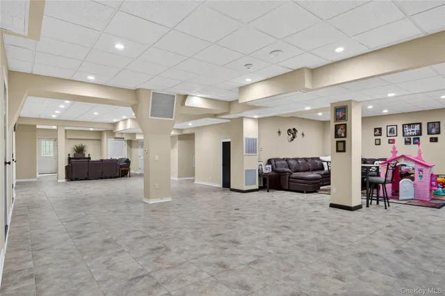a view of a house with a big yard and large trees