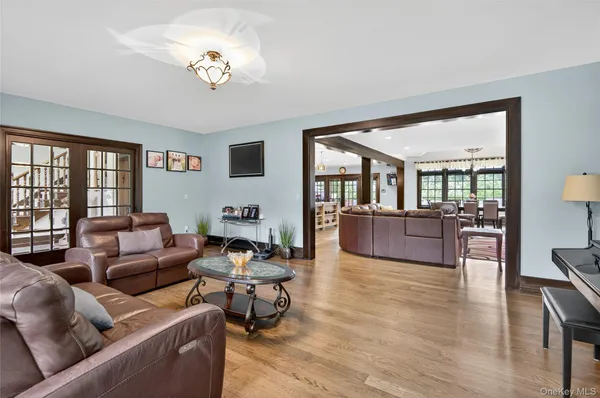a living room with fireplace furniture and a chandelier