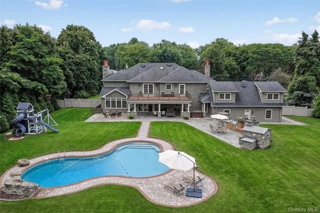 a aerial view of a house with a yard table and chairs