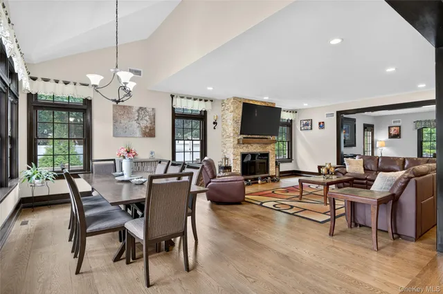 a living room with furniture wooden floor and a large window