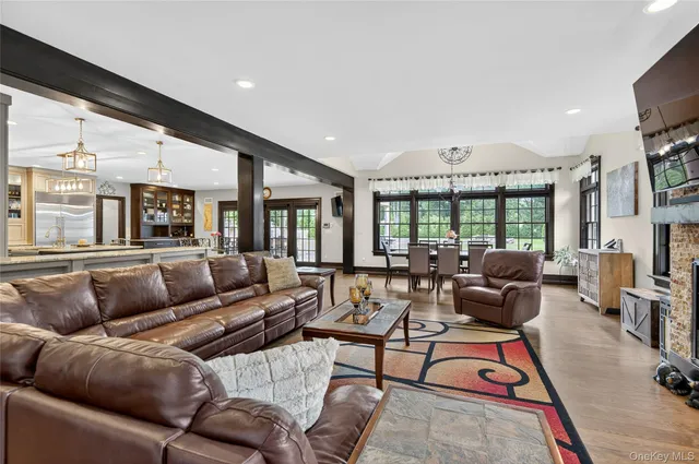 a dining room with furniture a fireplace and wooden floor