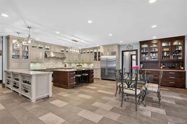 a kitchen with stainless steel appliances granite countertop a sink a stove and a refrigerator