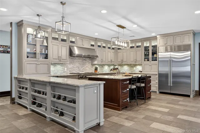 a kitchen with granite countertop a sink stainless steel appliances and cabinets