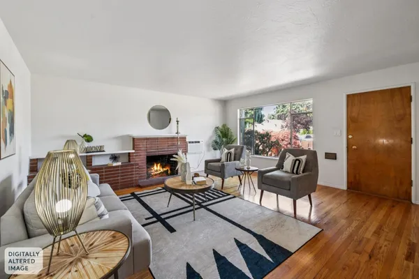 a living room with furniture a fireplace and a potted plant