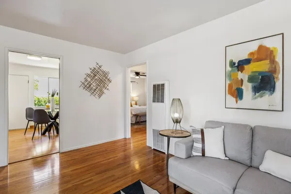 a kitchen with stainless steel appliances granite countertop a table chairs sink and cabinets