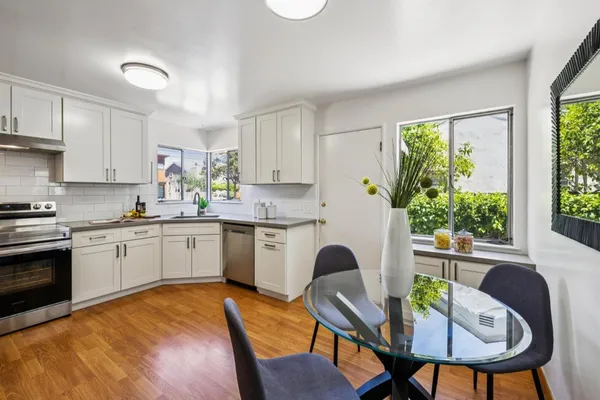 a kitchen with a sink cabinets and window