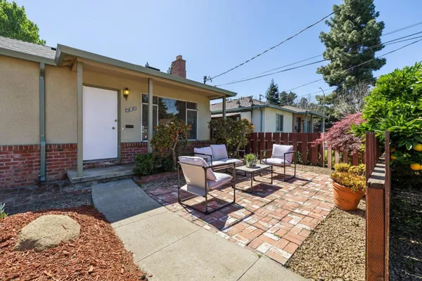 a view of a patio with table and chairs and potted plants