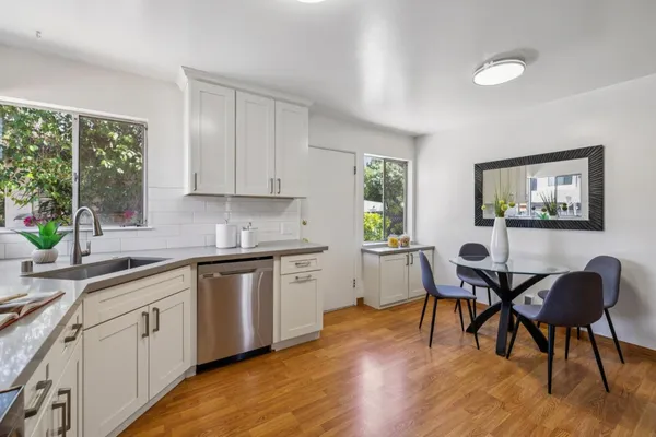 a view of a kitchen counter top a oven and potted plant