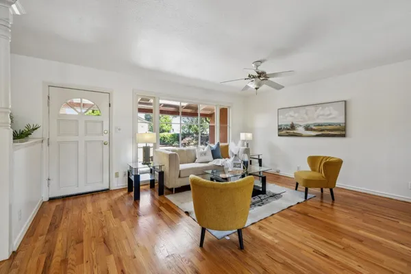 a bedroom with natural light and wooden floor