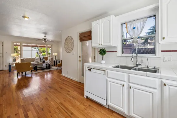 a bathroom with a bathtub a sink and a large mirror