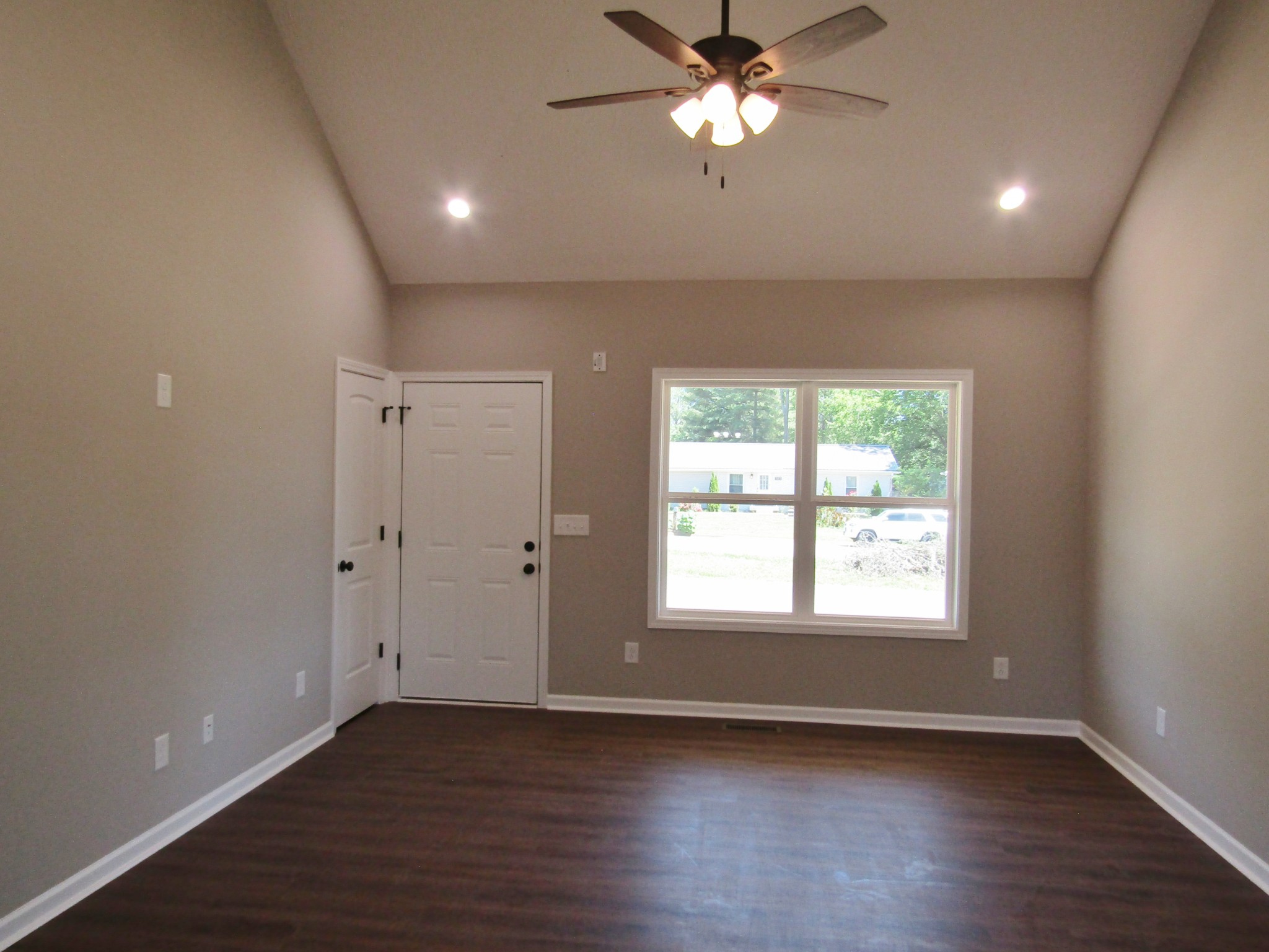 470 Crescent Factory Road Lawrenceburg, TN 38464 - Photo 3 of 15 a view of an empty room with wooden floor and a window