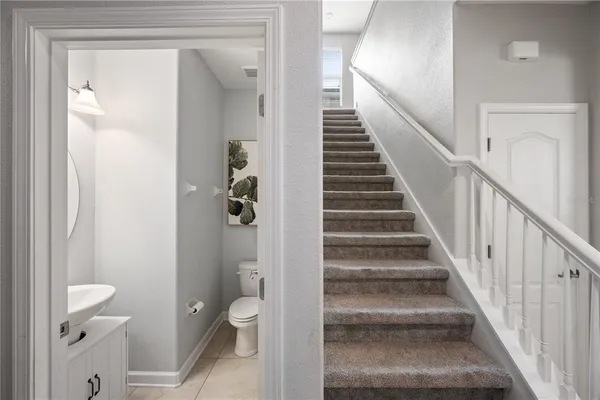 a view of a hallway with wooden floor and entryway