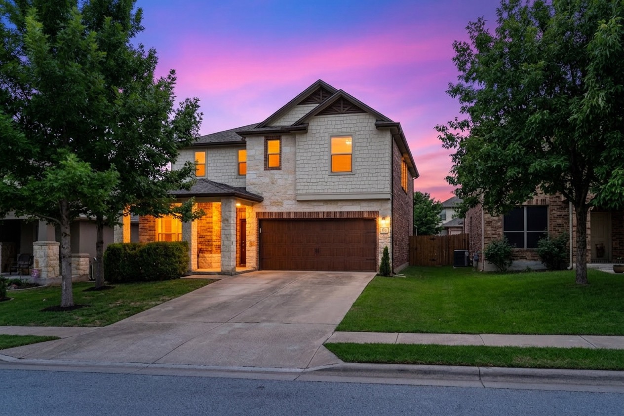 Two-story residence featuring a stone and siding exterior with a prominent two-car garage