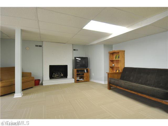 9045 Fantasy Road Lewisville, NC 27023 - Photo 12 of 15 Playroom. Basement playroom with fireplace
