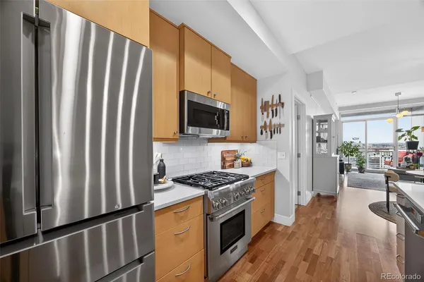 a kitchen with granite countertop a refrigerator stove and sink