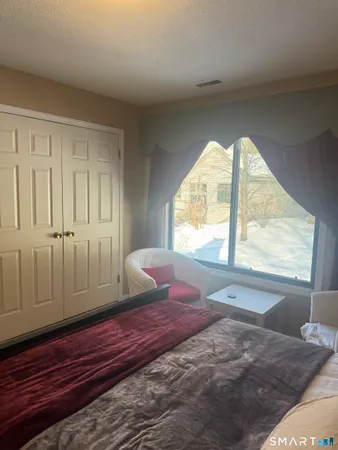 a bedroom with a bed and a desk