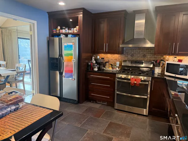 a sign that is sitting on a wooden fence