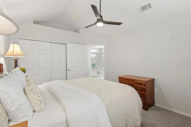 a bed room with a bed and a lamp