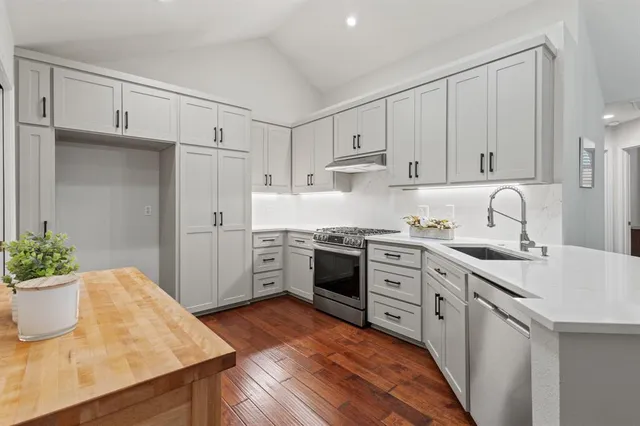 a kitchen with a sink stove and cabinets