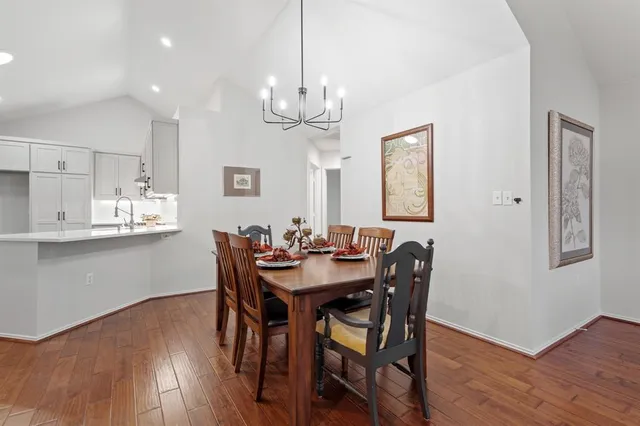 a view of a dining room with furniture wooden floor and chandelier