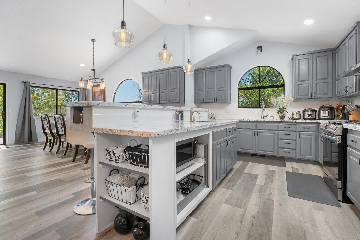 8170 Grizzly Flat Road Somerset, CA 95684 - Photo 13 of 43 a kitchen with stainless steel appliances a sink a stove a refrigerator cabinets and wooden floor
