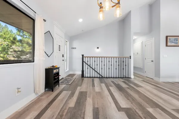 a view of a room with wooden floor and windows