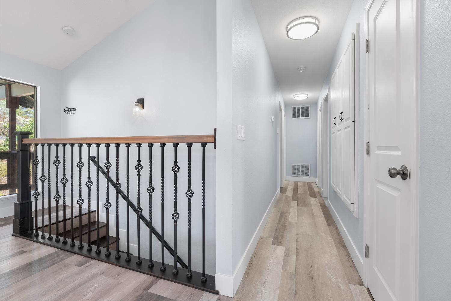 8170 Grizzly Flat Road Somerset, CA 95684 - Photo 19 of 43 a view of a hallway with wooden floor and a bathroom