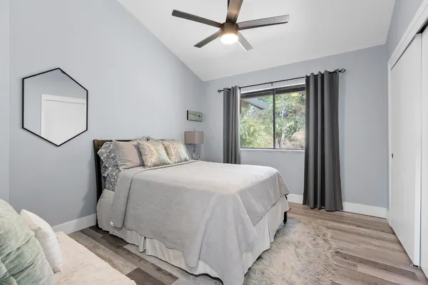 a bedroom with a bed and a window