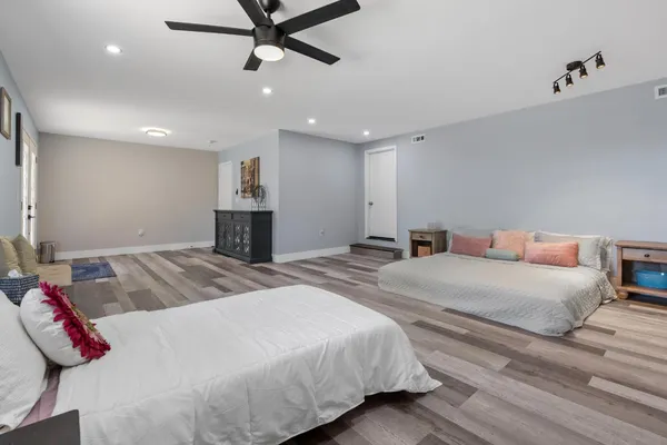 a bedroom with a large bed and a chandelier