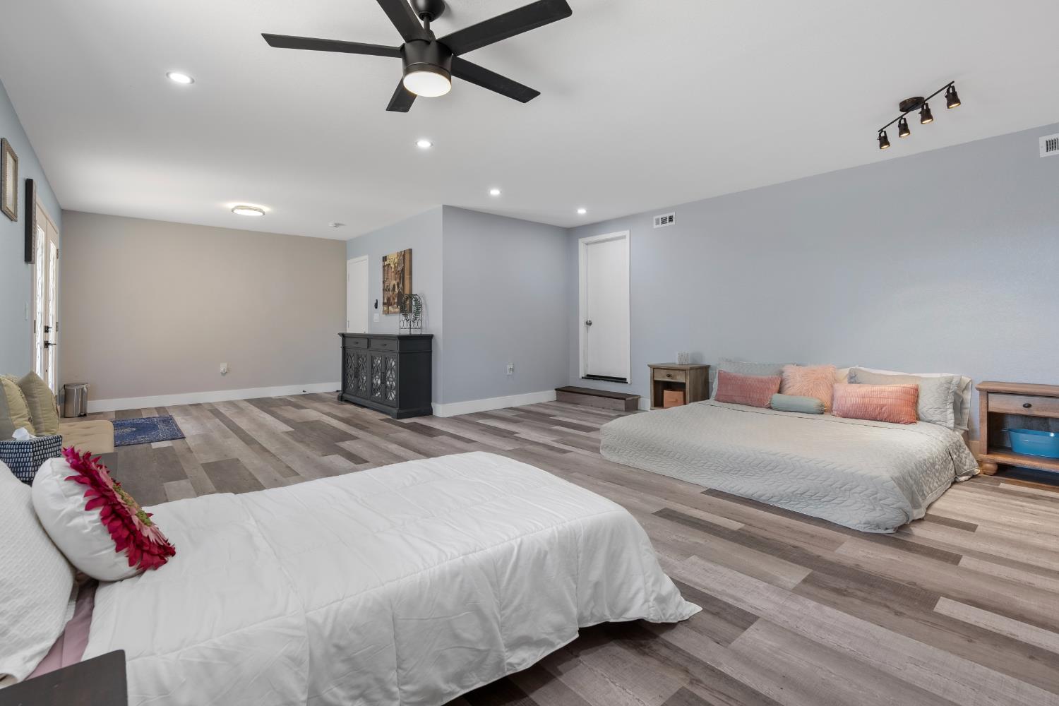 8170 Grizzly Flat Road Somerset, CA 95684 - Photo 33 of 43 a bedroom with a large bed and a chandelier