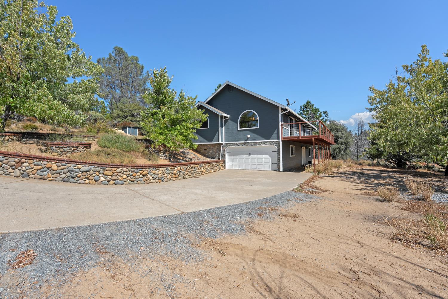 8170 Grizzly Flat Road Somerset, CA 95684 - Photo 35 of 43 a view of a house with a wooden fence