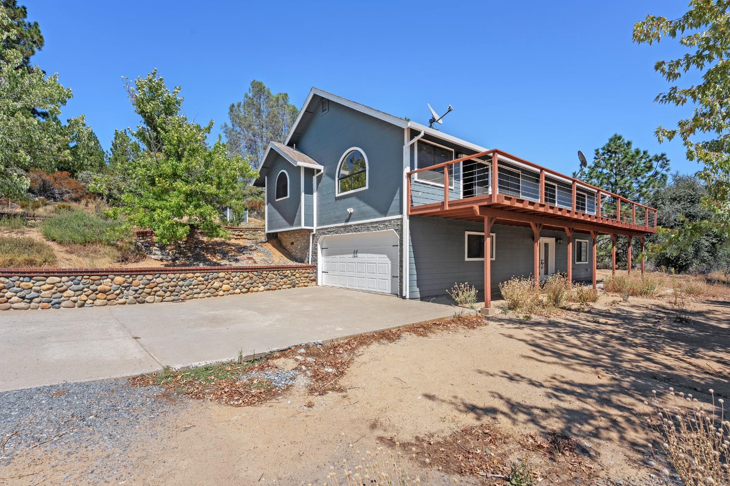 8170 Grizzly Flat Road Somerset, CA 95684 - Photo 36 of 43 a front view of a house with a wooden space