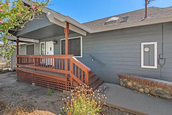 a view of a house with wooden fence