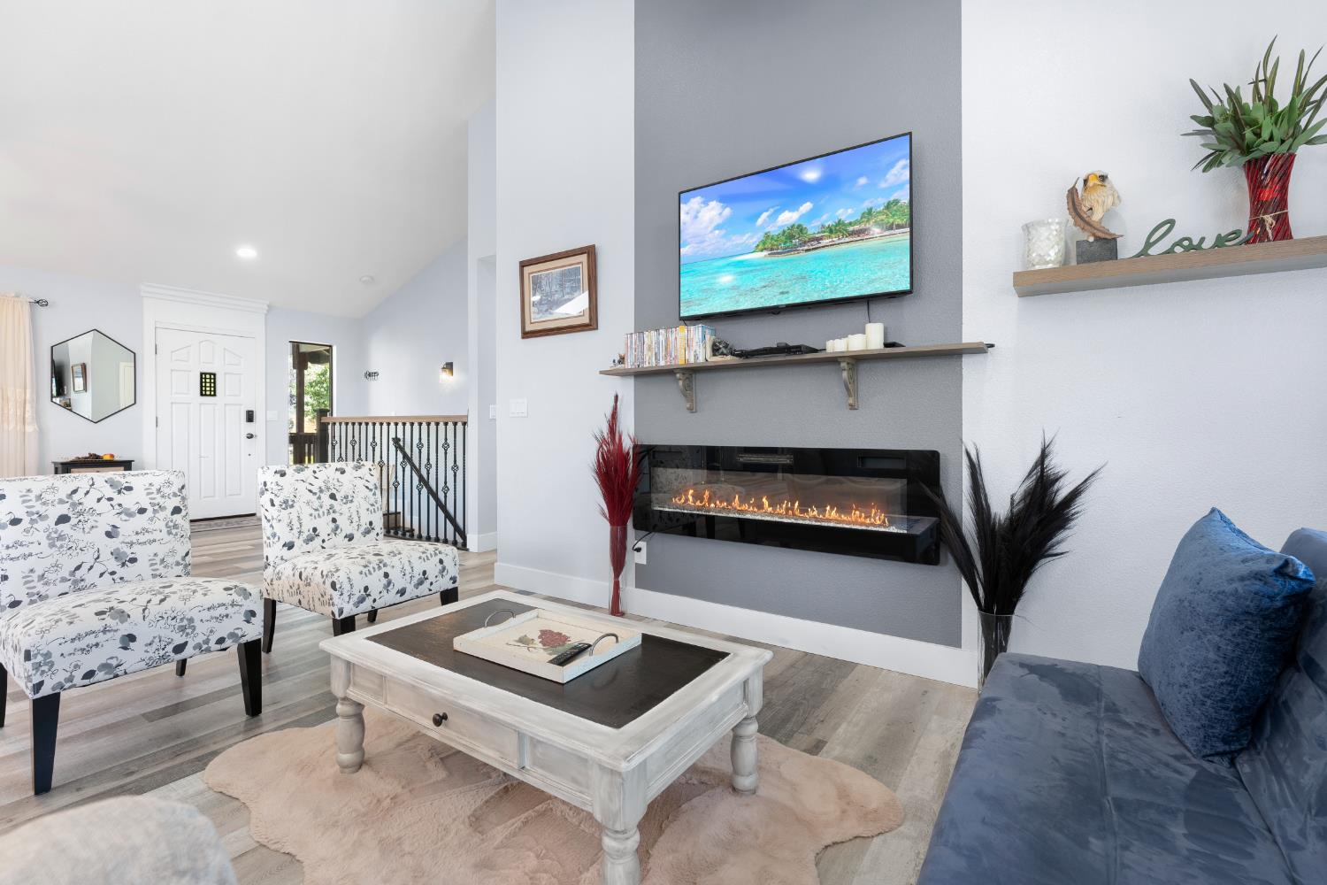8170 Grizzly Flat Road Somerset, CA 95684 - Photo 10 of 43 a living room with furniture a flat screen tv and a fireplace