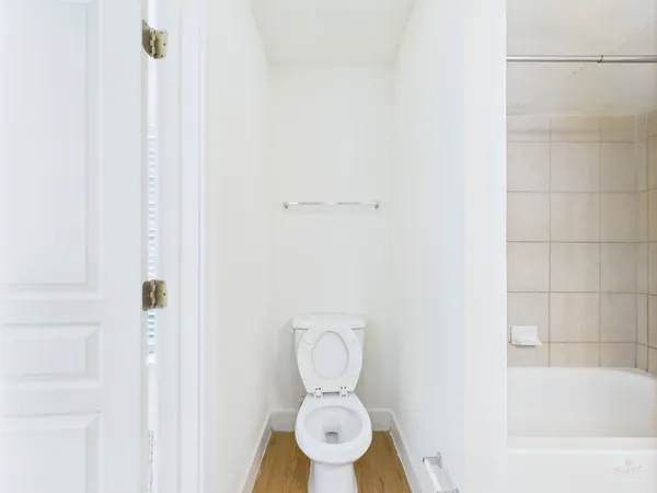 a bathroom with a toilet and a shower