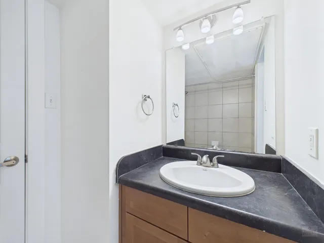 a white toilet sitting next to a shower