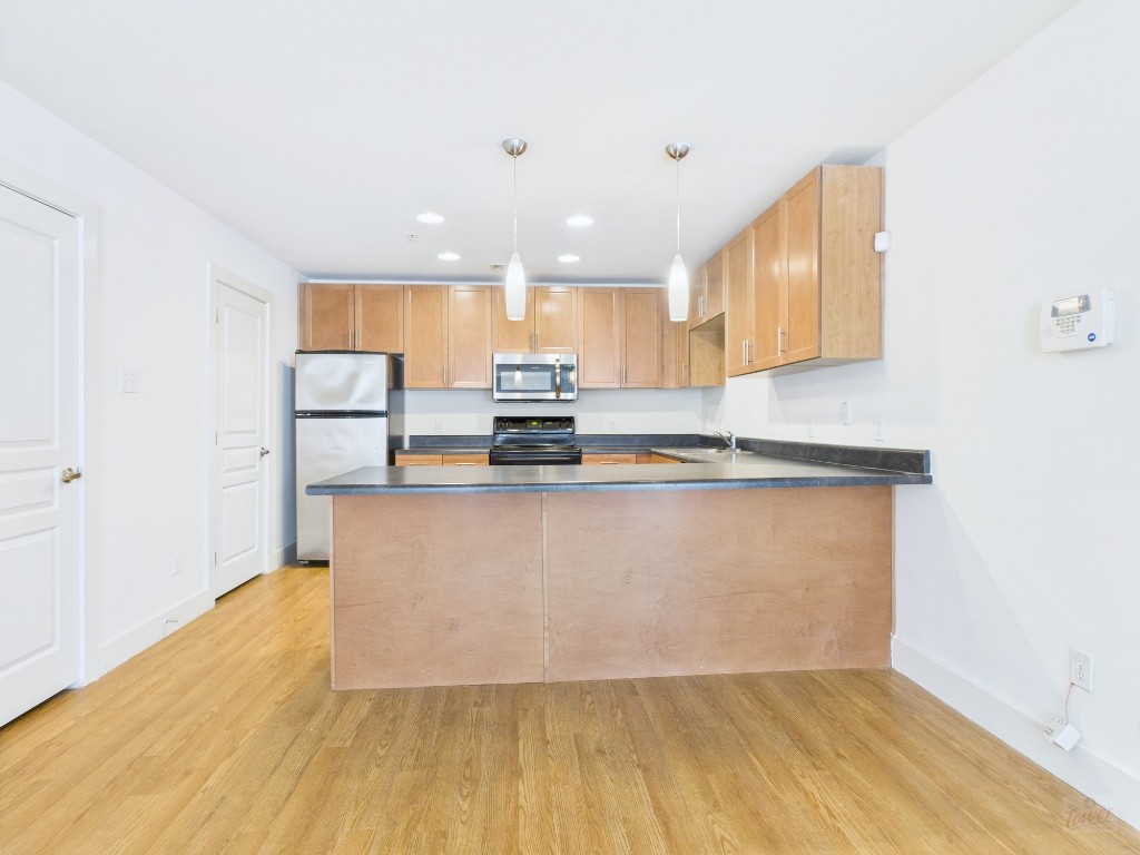 711 West 32nd Street, Unit 151 Austin, TX 78705 - Photo 4 of 21 a view of kitchen with stainless steel appliances granite countertop refrigerator sink and stove