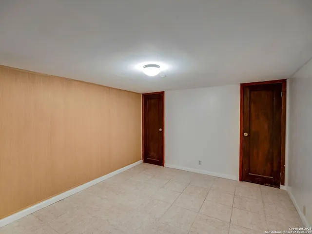 a view of a yard with plants and a tree