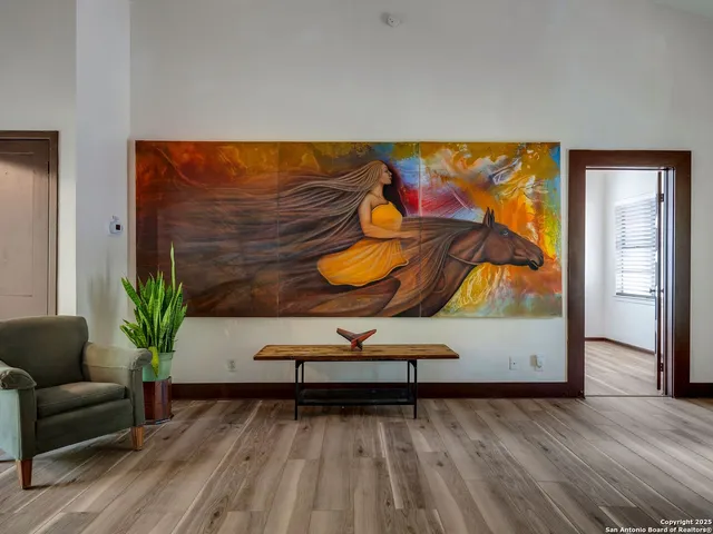 a view of a room with furniture wooden floor and windows