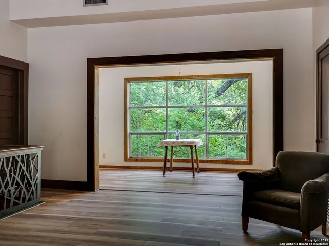 a view of a room with furniture window and wooden floor