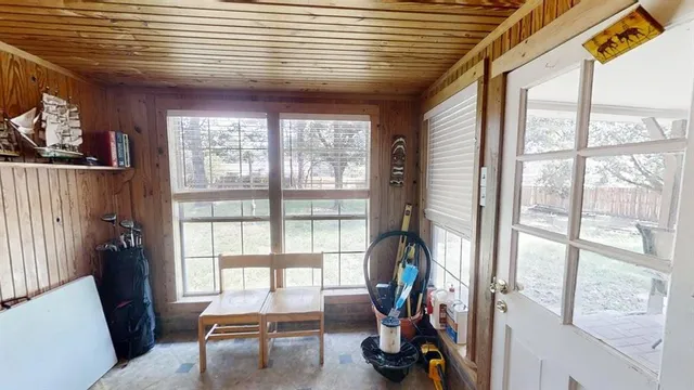 a view of a livingroom with workspace and a large window