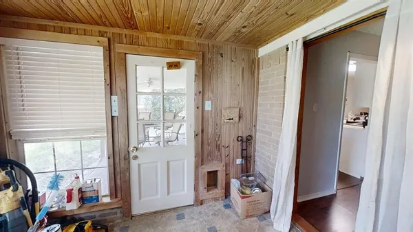 a view of a hallway and a livingroom with furniture