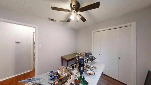 a view of a workspace with furniture and hardwood floor