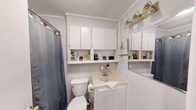 a kitchen with a sink a refrigerator and cabinets