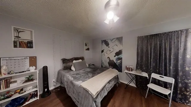 a bedroom with a bed and a tv